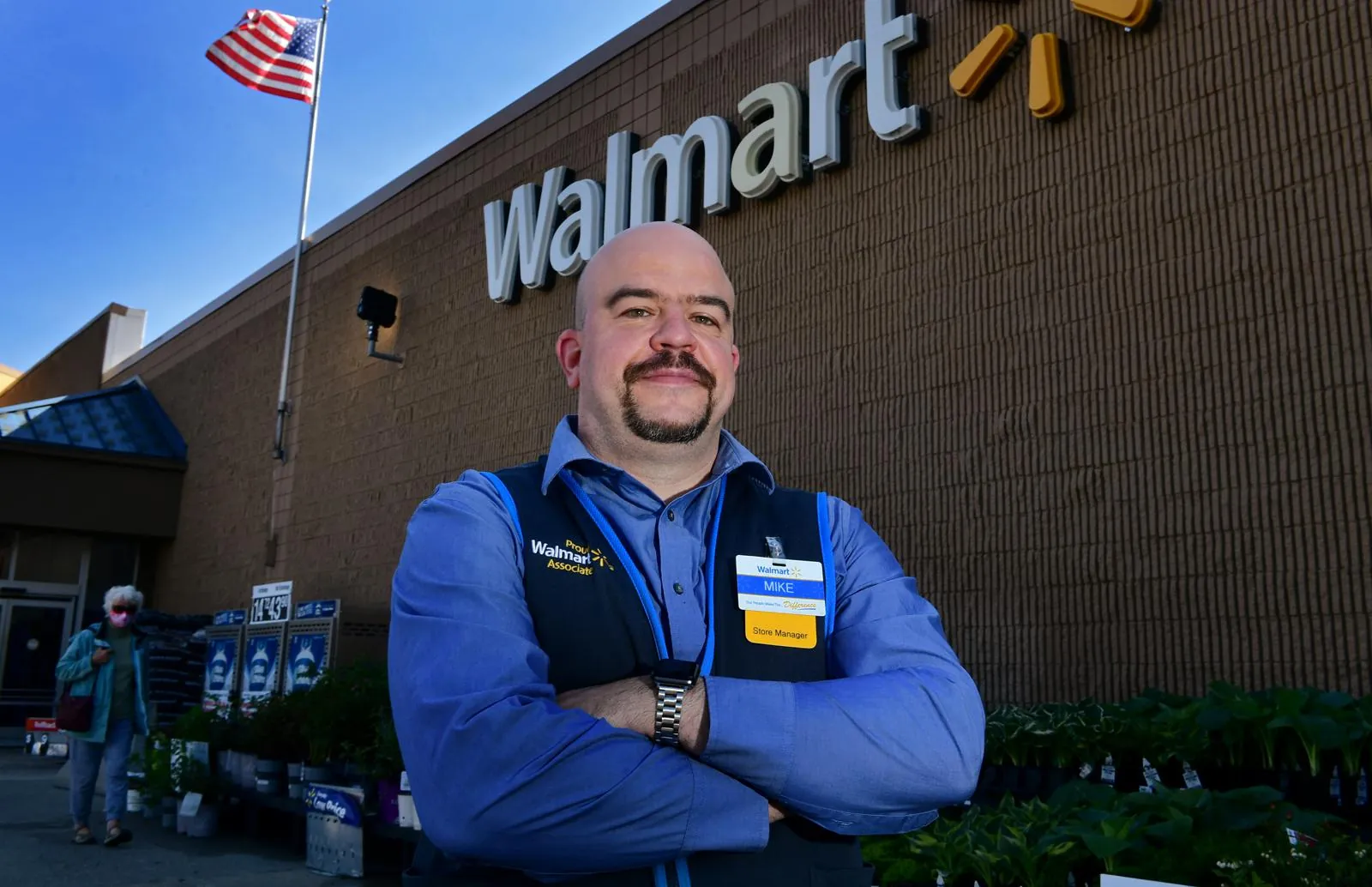 Walmart store manager standing outside a Walmart store